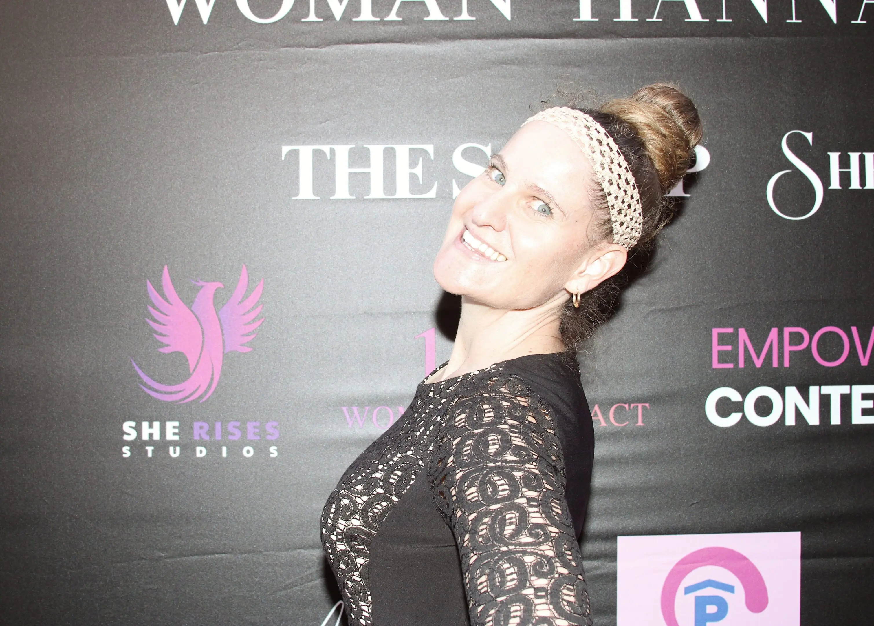 Smiling woman with a beaded headband poses at an event.